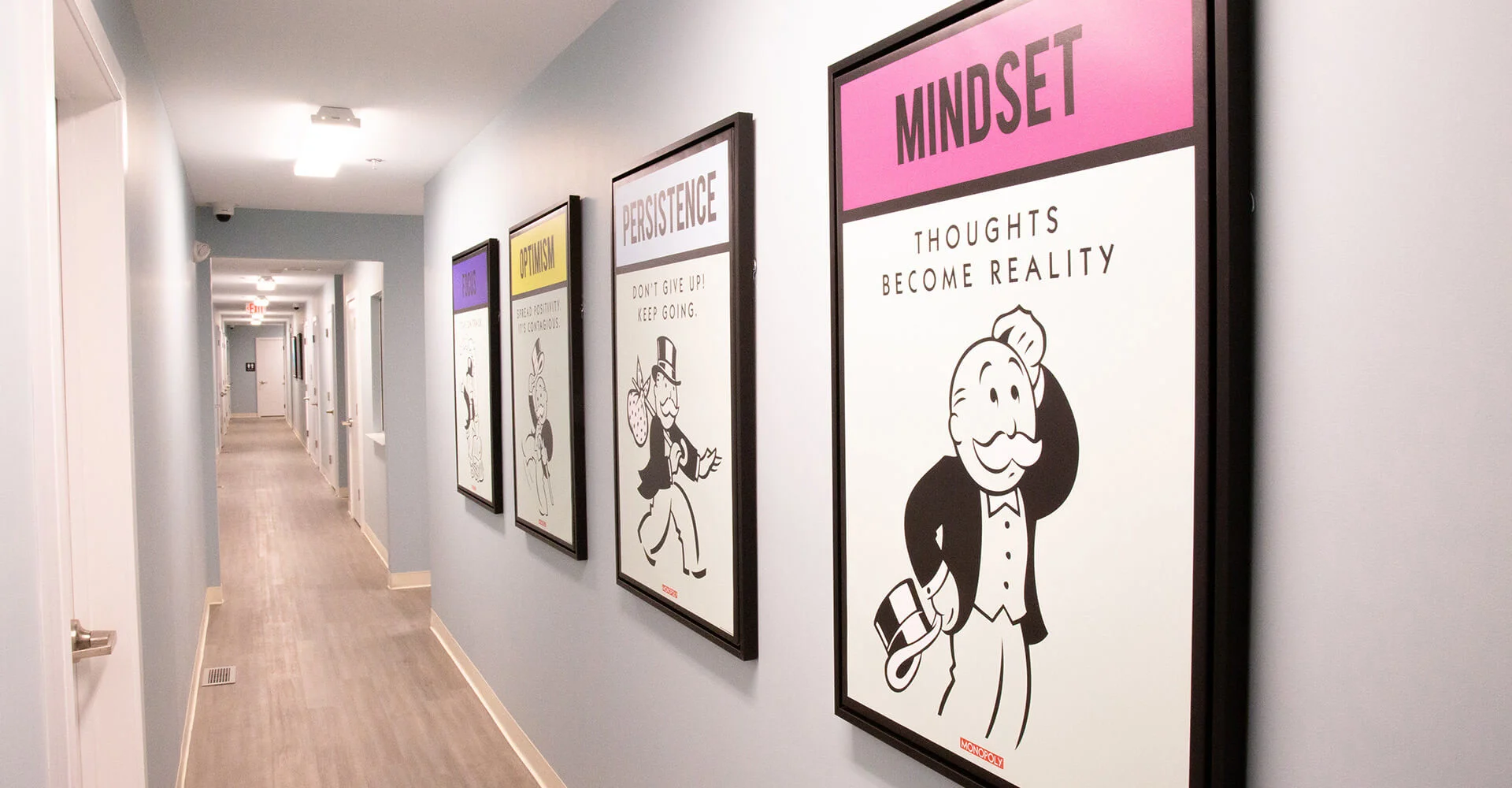 Hallway with doors and art.