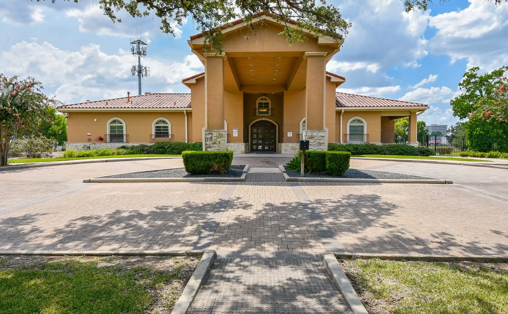 Rehab facility entrance with red-tiled roof and greenery.
