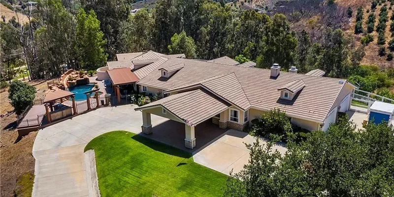 Aerial view of facility with driveway.