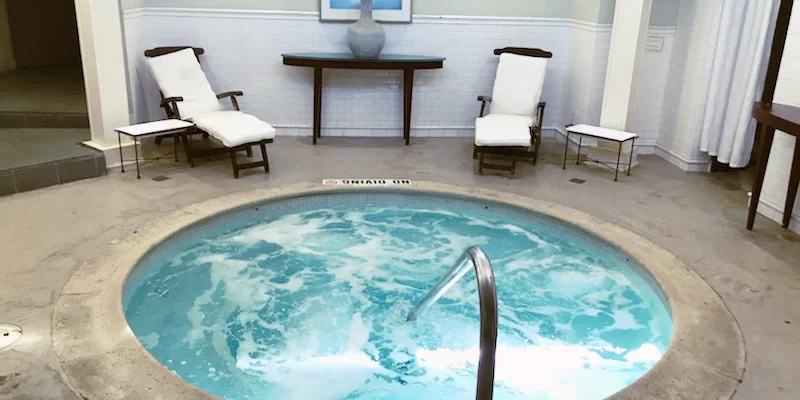 A small indoor spa with lounge chairs.