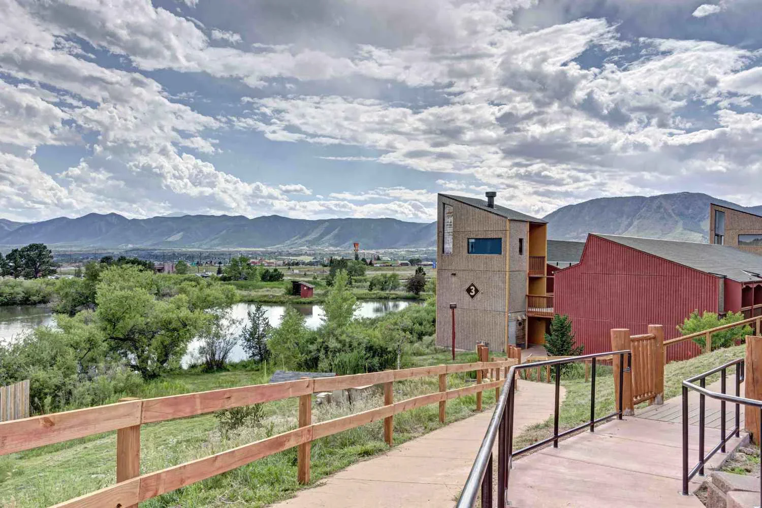 Walkway to facility with lake in vew.