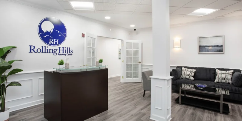 Rolling Hills reception with a couch and chairs by the desk.
