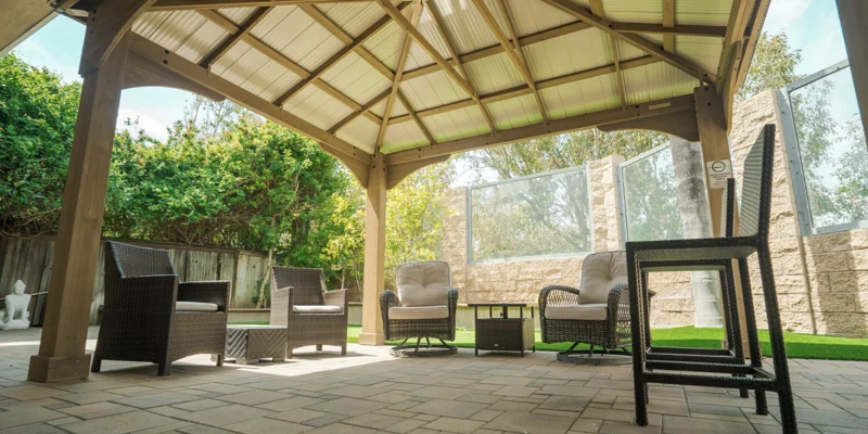 Shaded Outdoor common area with chairs arranged in a circle.