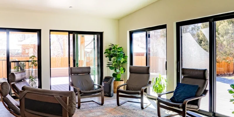Bright room with circle of chairs for group therapy