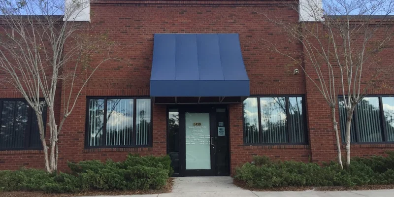Facility entrance with awning and signage.
