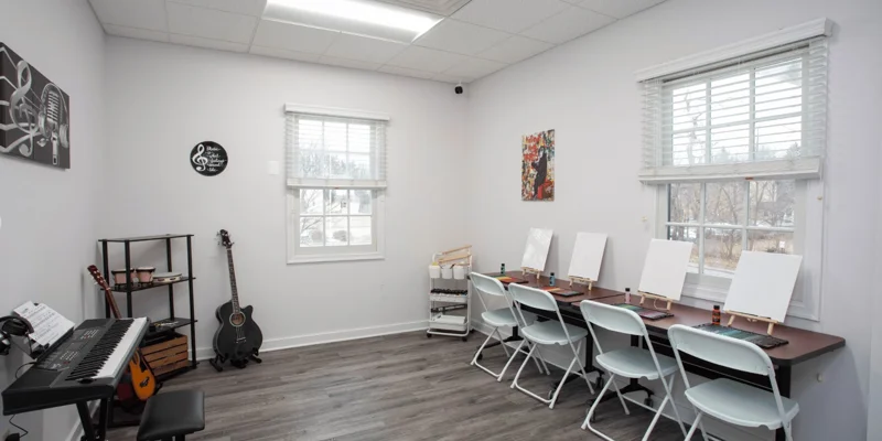 Recreational room with art supplies and instruments.