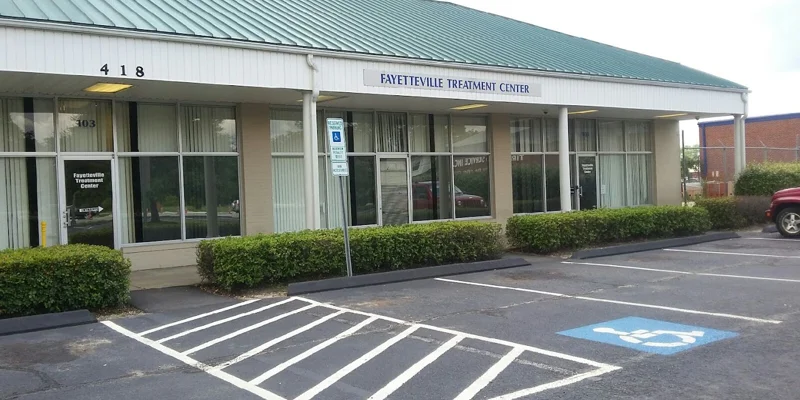 Facility exterior with parking and accessibility space.