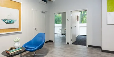 A waiting area with a blue chair and modern decor.