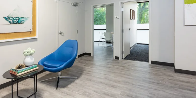 A waiting area with a blue chair and modern decor.