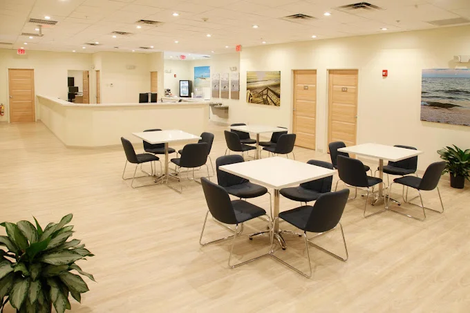 Dining area with tables and chairs.