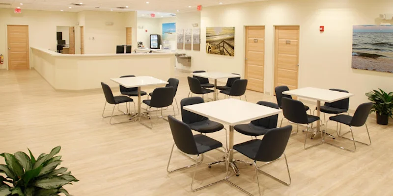 Dining area with tables and chairs.