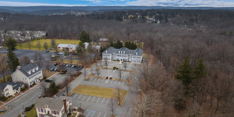 Aerial view of rehab facility showing building and parking.