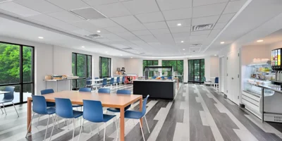 A modern cafeteria with large windows and seating.