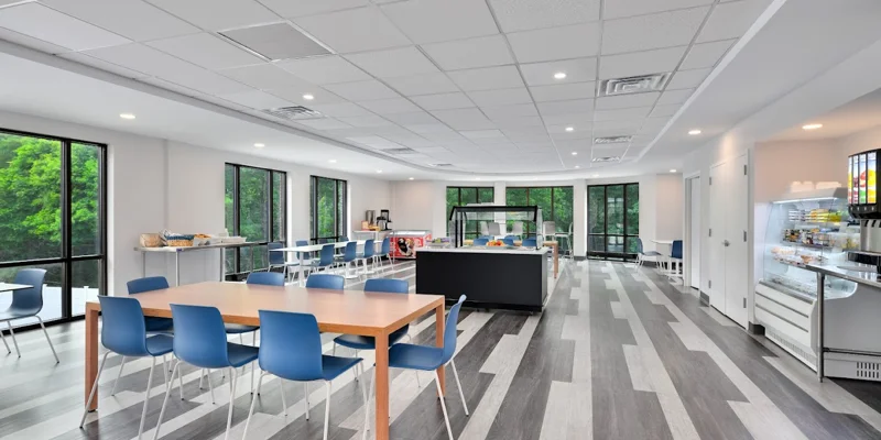 A modern cafeteria with large windows and seating.