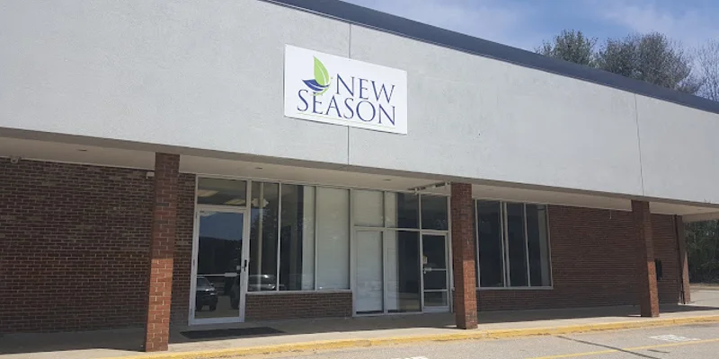 Facility exterior with extrance, accessible parking and signage.