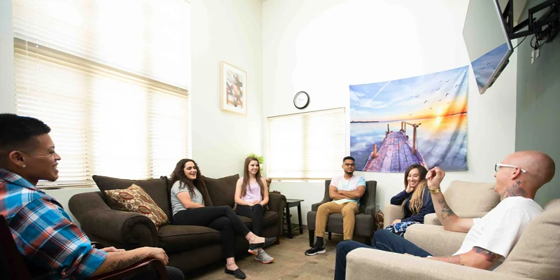 Small group counseling session with sofas.