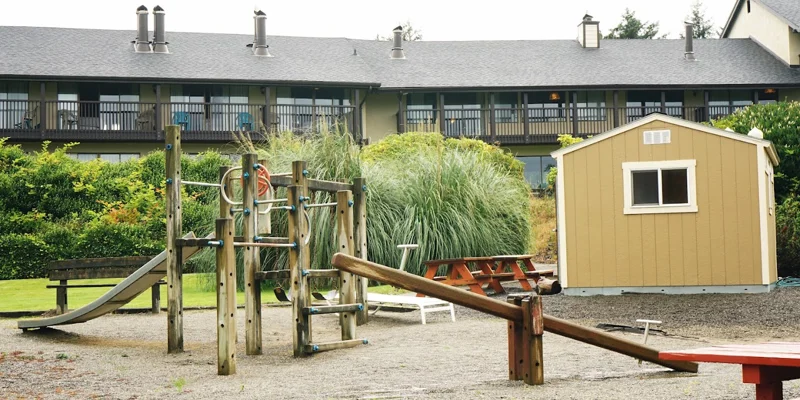 A rehab facility playground with slides and benches.