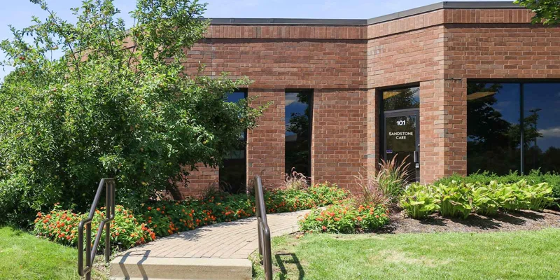 Brick building with '101 Sandstone Care' signage.