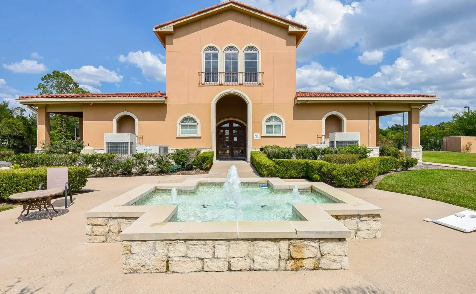 Exterior of a two-story rehab facility with a red tile roof.