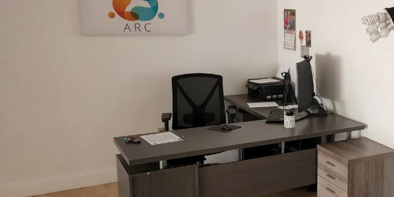 Office space with desk and signage.
