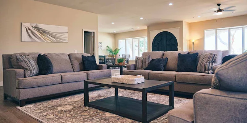 Spacious living room with plush gray sofas.