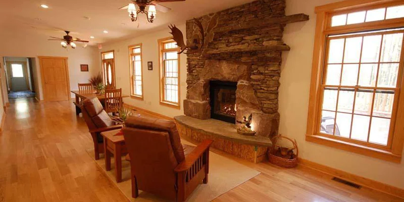  cozy living room with a stone fireplace and wooden furniture