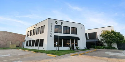 White two-story rehab center building with large front windows
