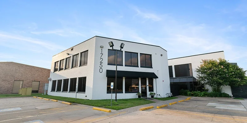White two-story rehab center building with large front windows