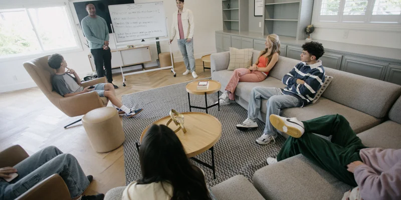 Group therapy session with young adults in a casual setting