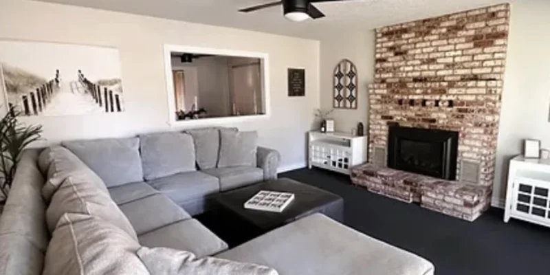 Lounge area with couches in front of firplace.