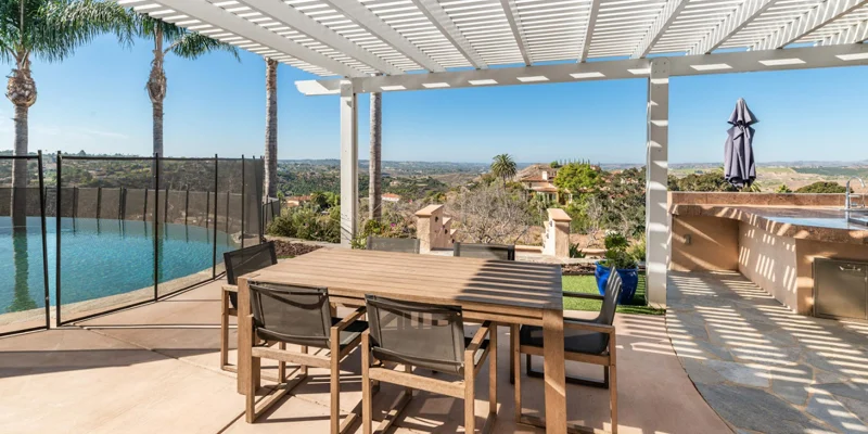 shaded outdoor seating area nest to a barbaque space.