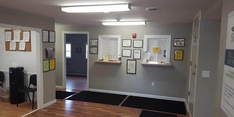 Lobby with reception window and offices in view.