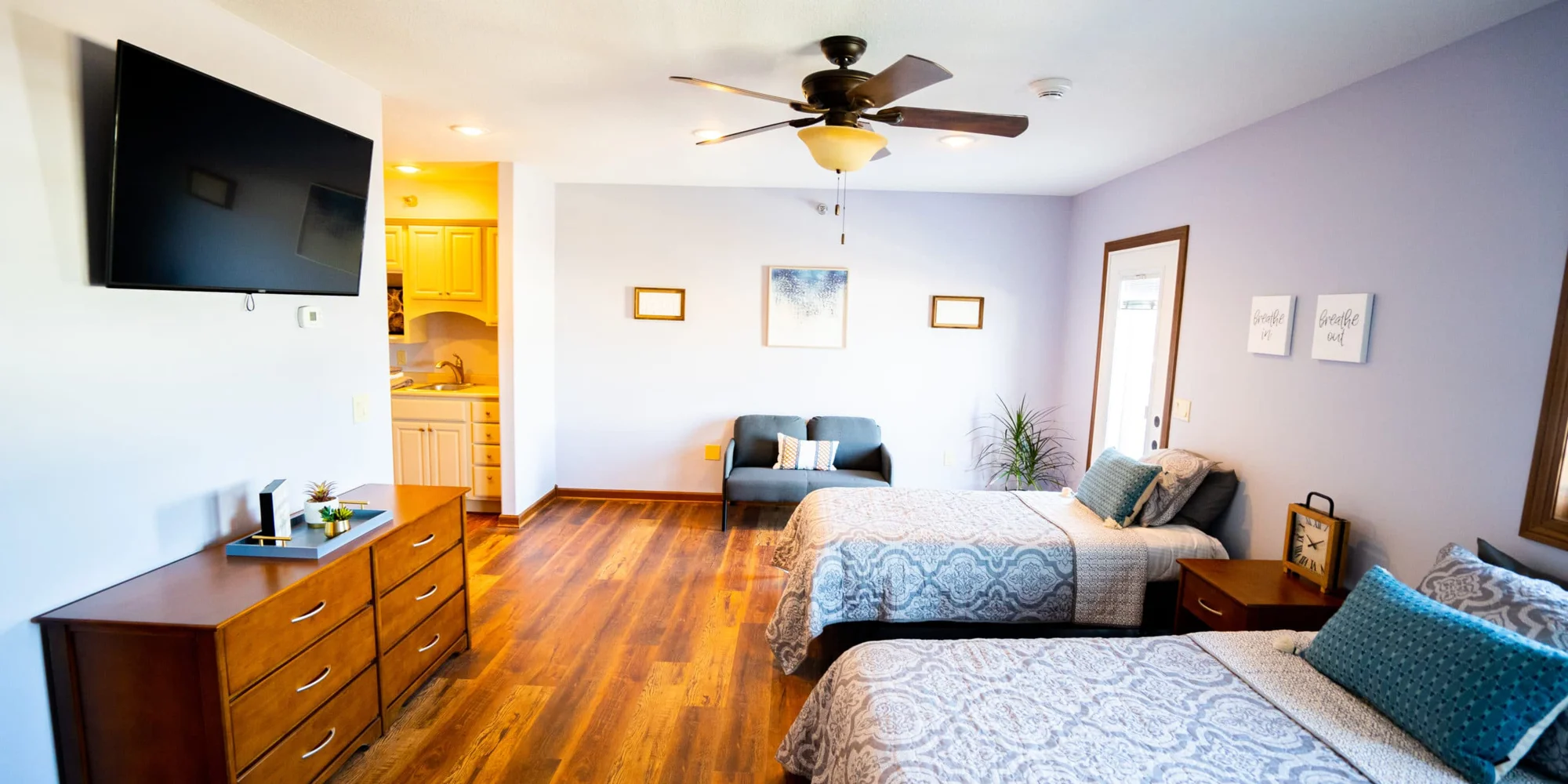 A bright shared bedroom with twin beds and modern decor.