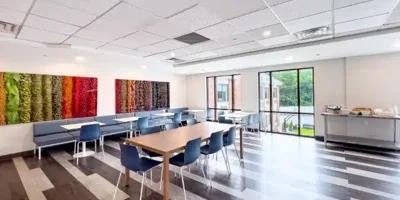 A bright dining room with colorful wall art.