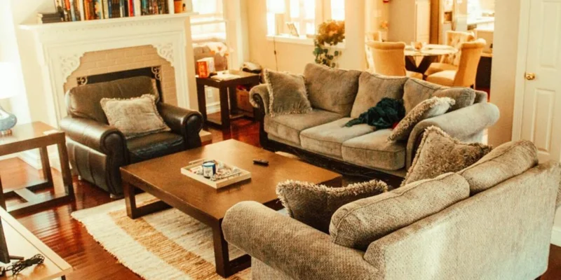 A warmly lit living area with sofas and a coffee table