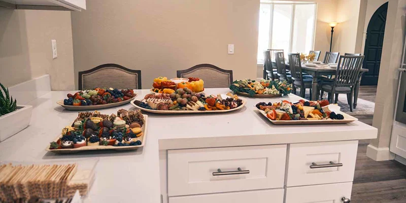 Kitchen counter with a variety of fresh food platters.