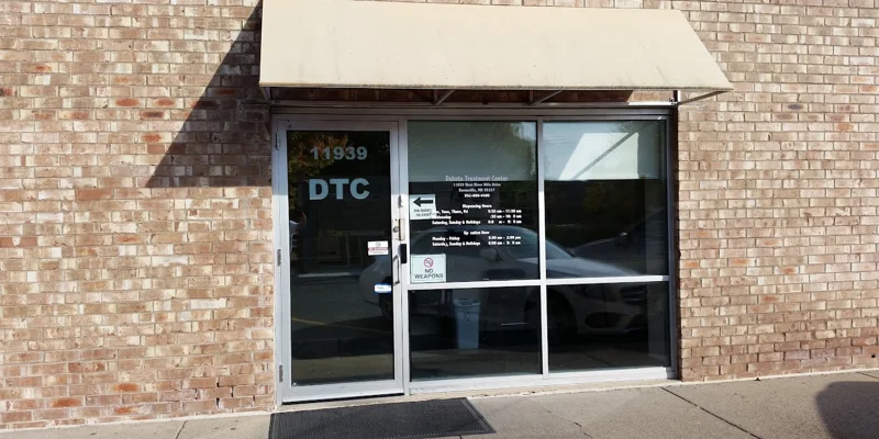Entrance with glass doors and signage.