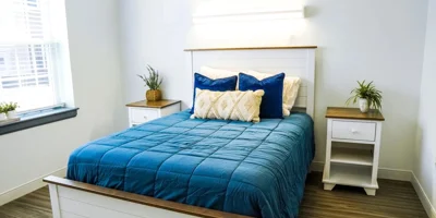 Private bedroom with a bed and side-tables.