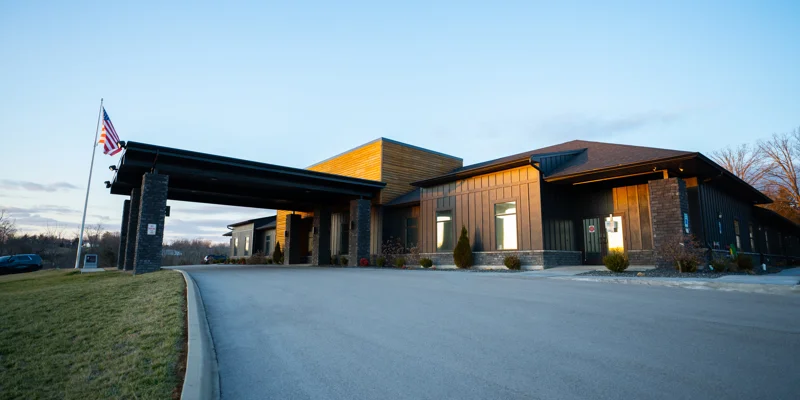 Rehab center exterior with flag and covered entrance