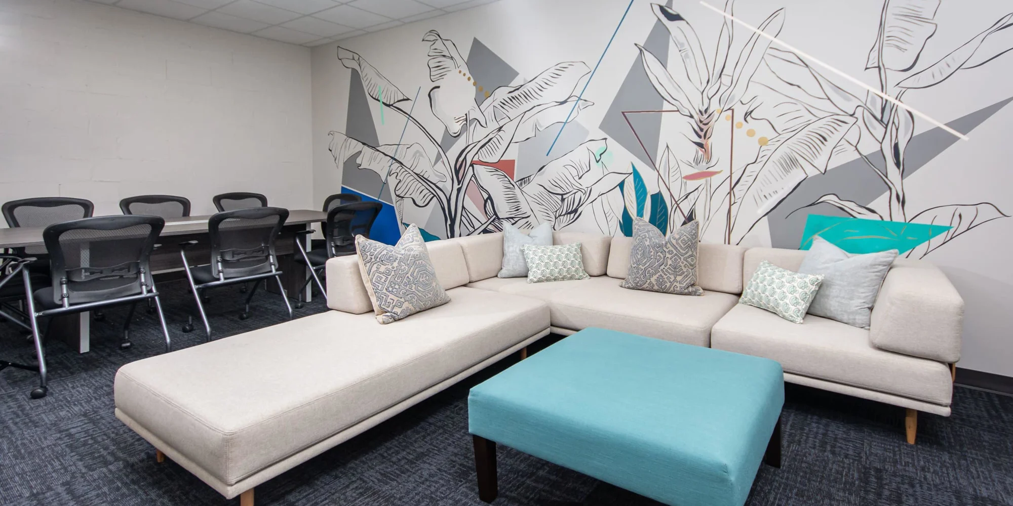 A modern meeting space with a white sectional sofa.