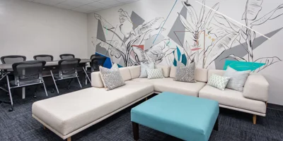 A modern meeting space with a white sectional sofa.