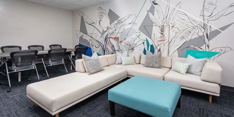 A modern meeting space with a white sectional sofa.