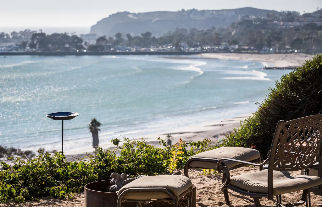 Beachfront seating with chairs and a fire pit.
