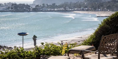 Beachfront seating with chairs and a fire pit.
