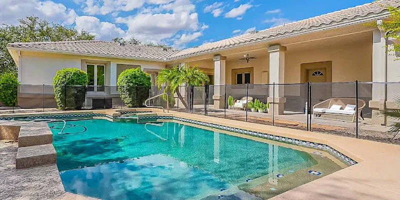Poolside view of a rehab facility with seating.