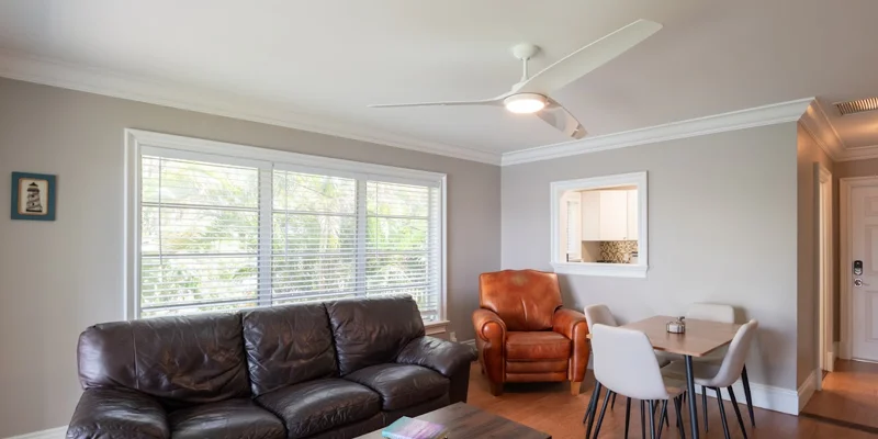 Living room with couch, table, and large window