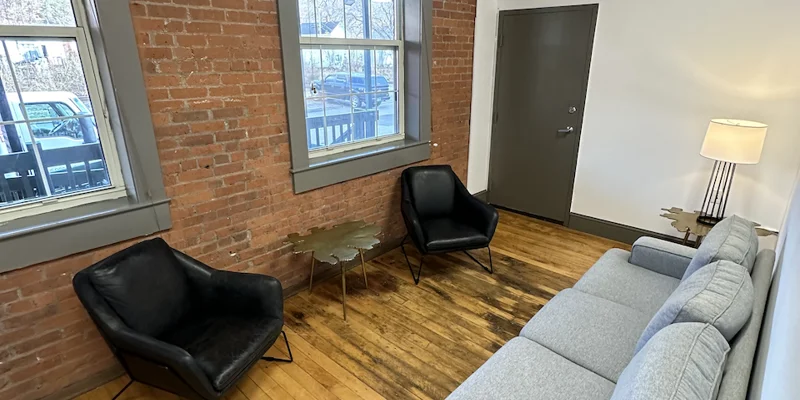 Small seating area with black chairs and a gray couch