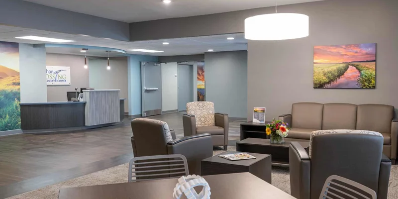 A spacious lobby with seating, a reception desk, and artwork.