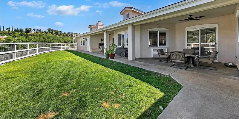 Backyard with a covered patio and seating.