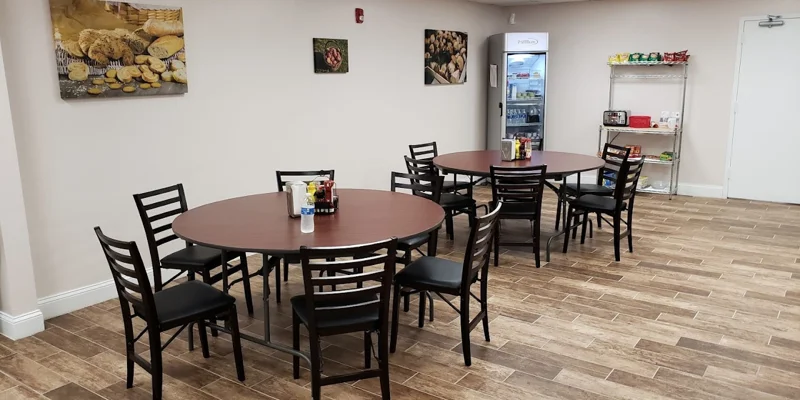 Dining area with round tables and snack station.